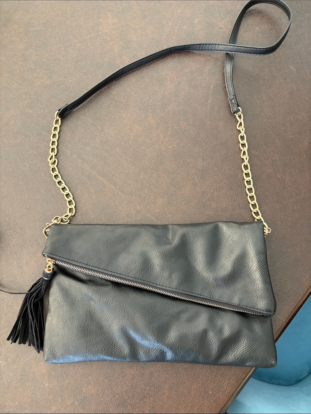 Elegant Black Crossbody Bag with Gold Chain and Tassel Accent